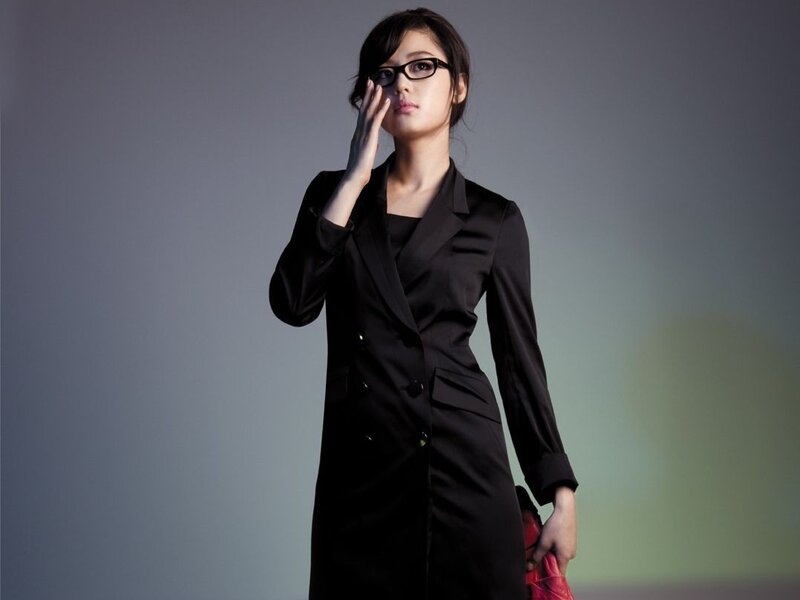woman in black suit with glasses