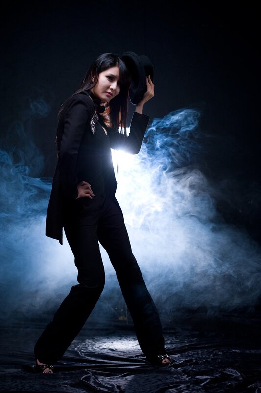 woman in black suit with hat