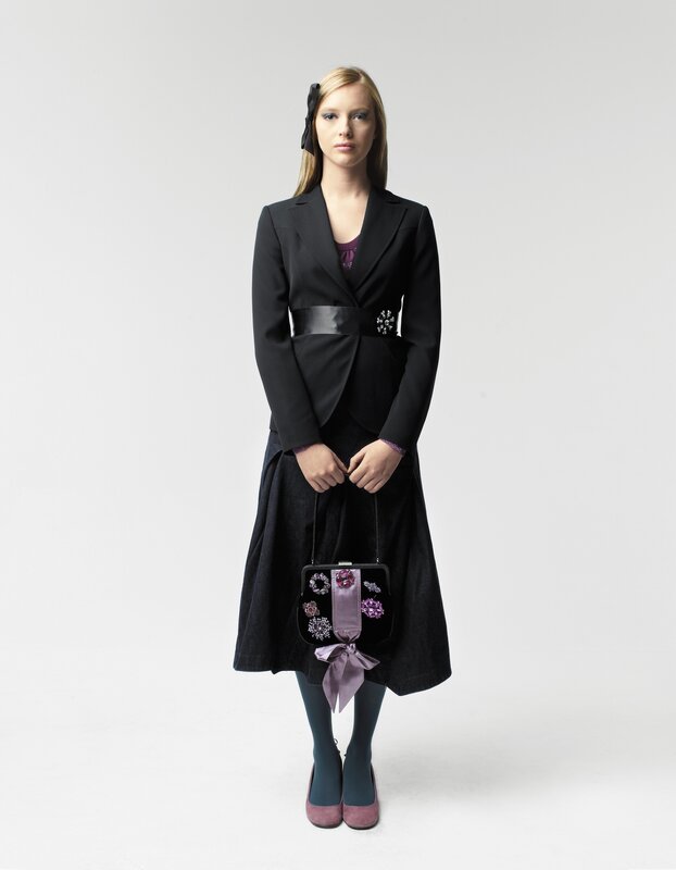 woman in black suit with purple accents