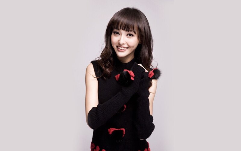 woman in black sweater smiling