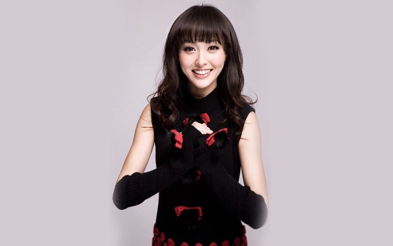woman in black sweater smiling