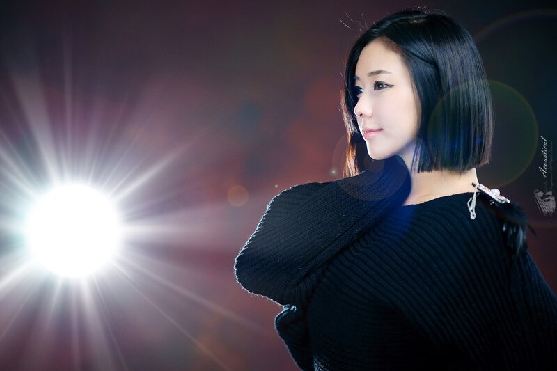 woman in black sweater with light