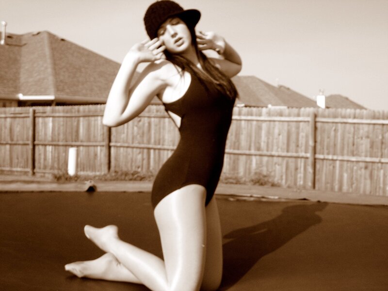 woman in black swimsuit kneeling