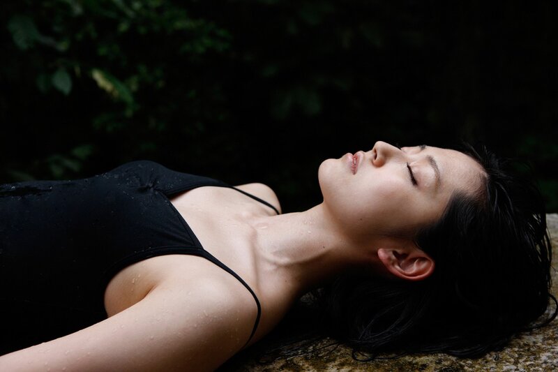 woman in black swimsuit lying down