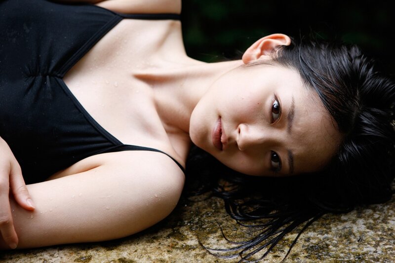 woman in black swimsuit lying down