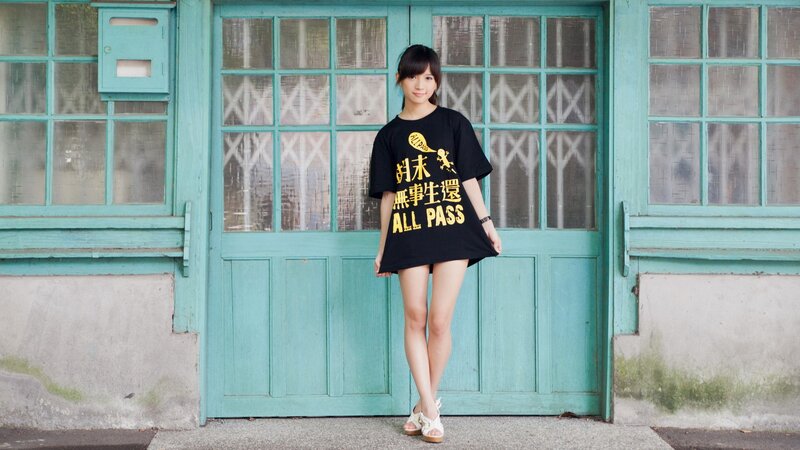 woman in black t-shirt standing by door