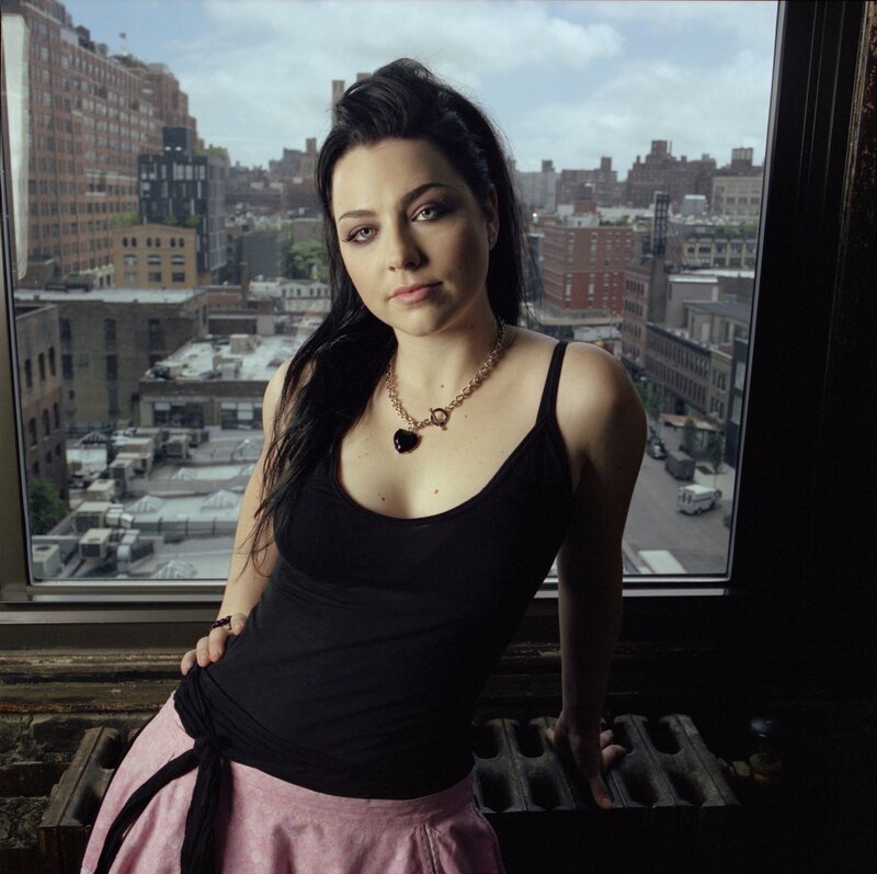 woman in black tank top by window
