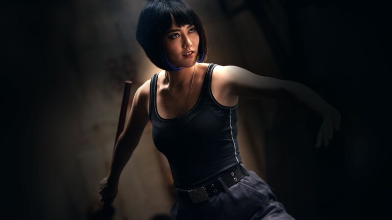woman in black tank top holding staff