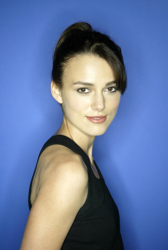 woman in black top against blue