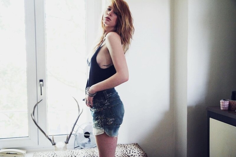 woman in black top and denim shorts