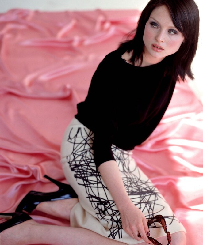 woman in black top and patterned skirt