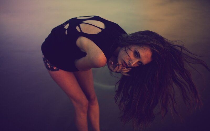 woman in black top bending forward