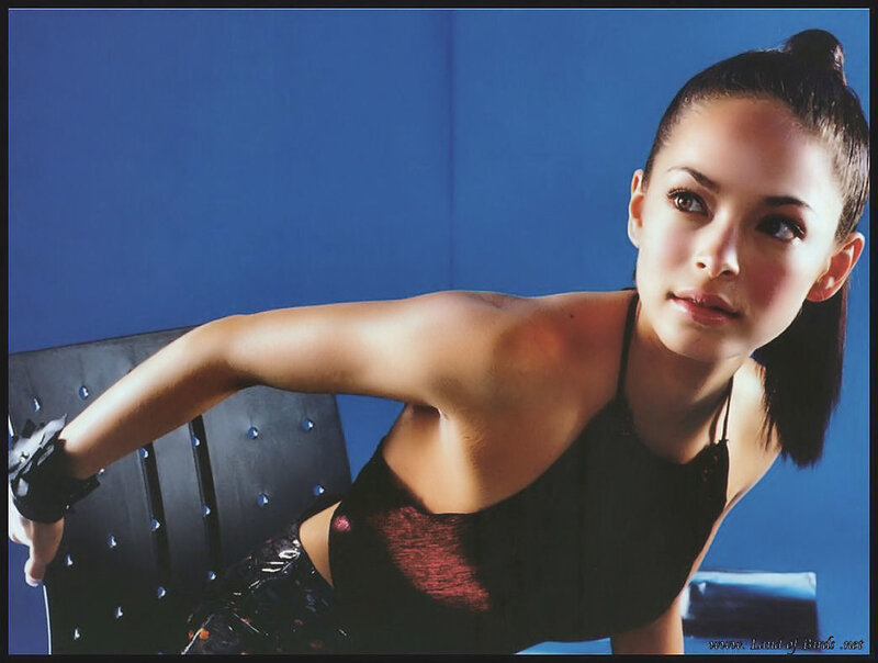 Woman in Black Top — Blue, Confident, Photograph, Blue Wall