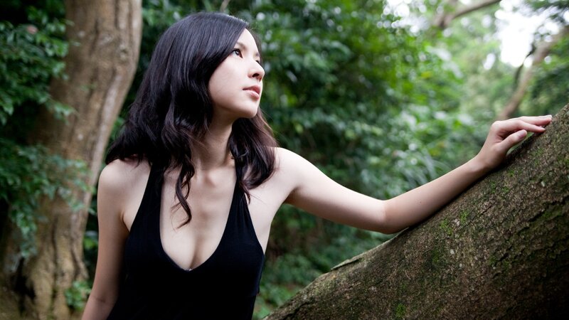 woman in black top by tree
