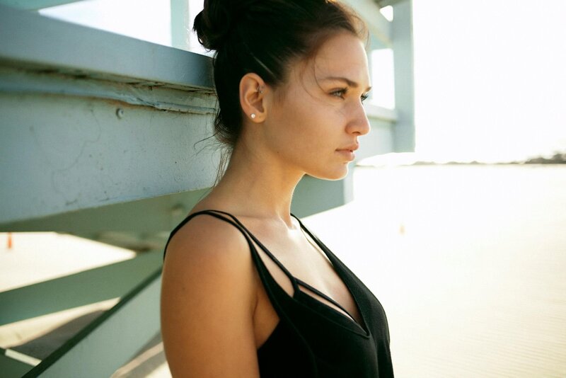woman in black top by water