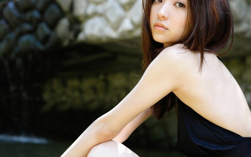woman in black top by water