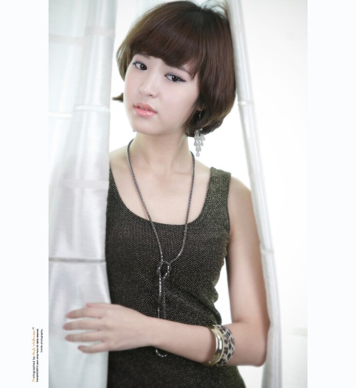 woman in black top by window