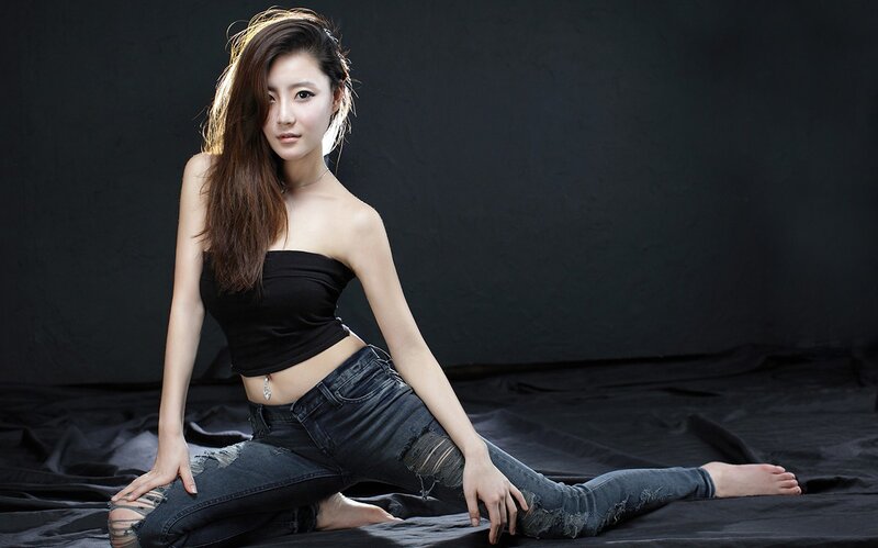Woman in Black Top — Dramatic, Photograph, Jeans, Black Background