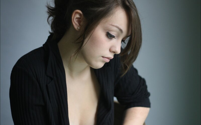 woman in black top looking down