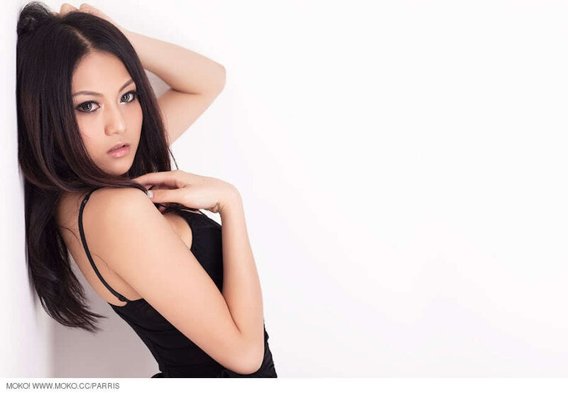 Woman in Black Top — Neutral, Photograph, Black Top, White Wall