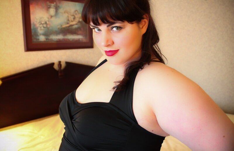 woman in black top on bed