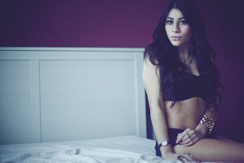 woman in black top on bed