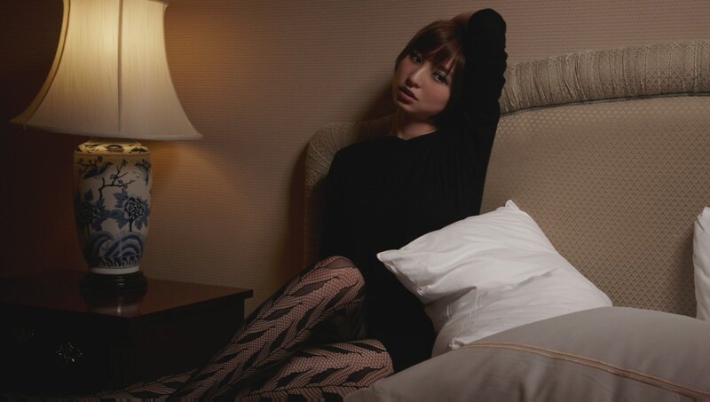 woman in black top on bed