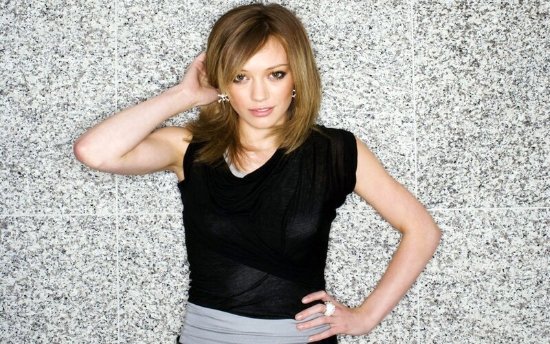 woman in black top posing