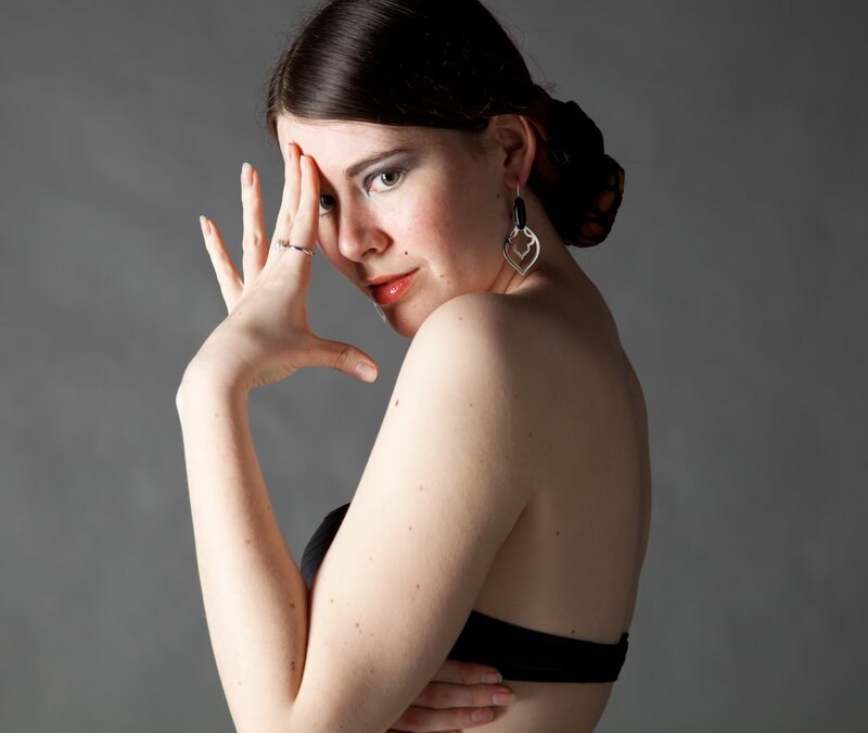 woman in black top posing