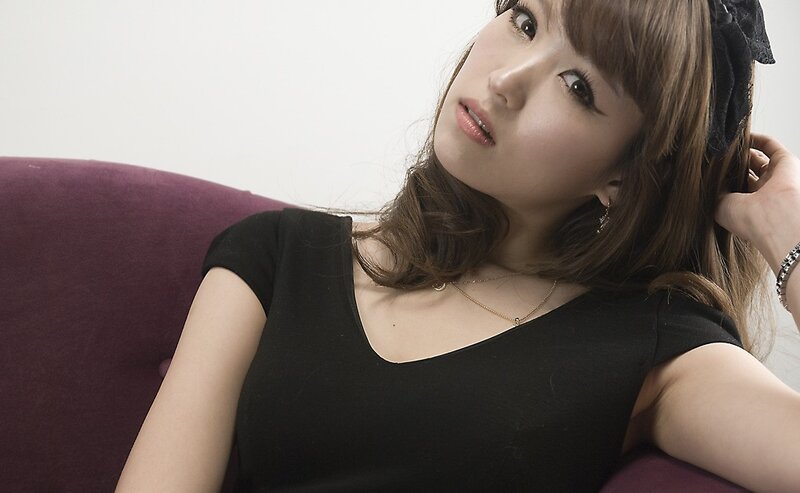 woman in black top sitting on couch