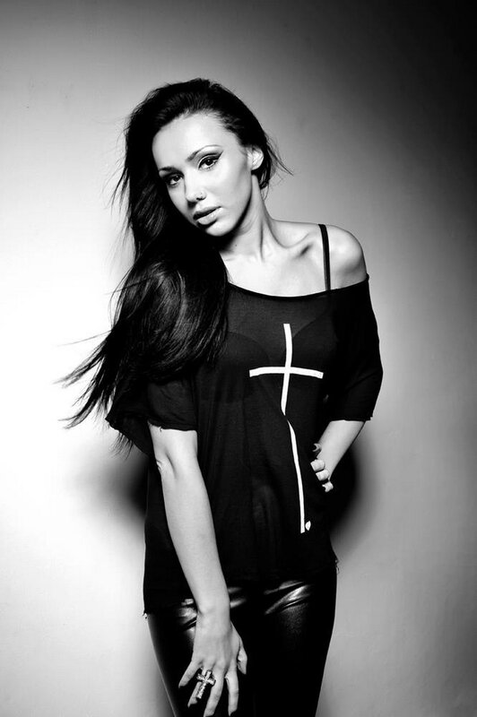 woman in black top with cross