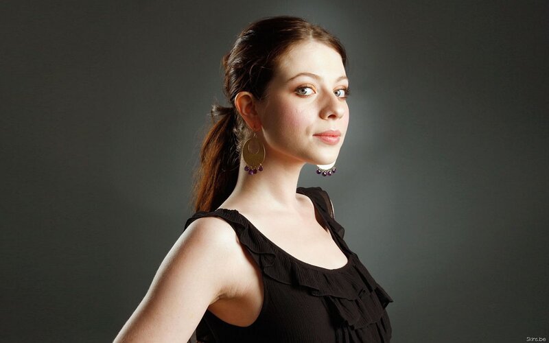 woman in black top with earrings