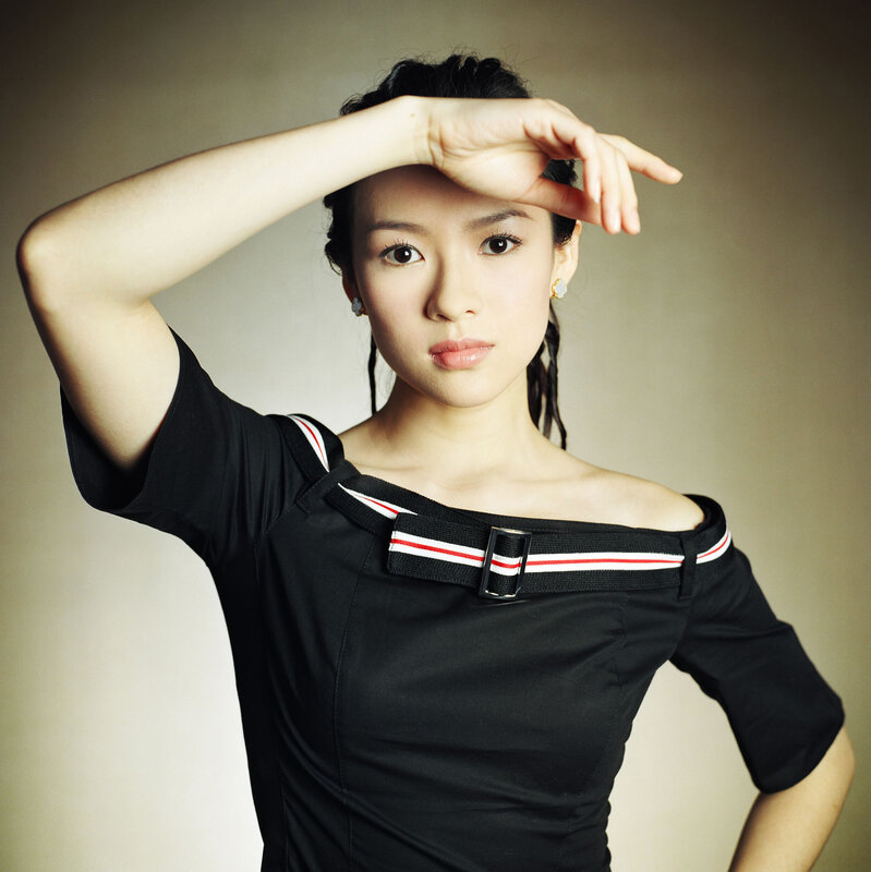 woman in black top with hand gesture