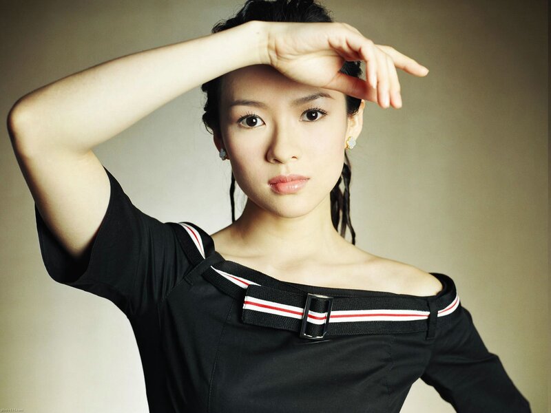 woman in black top with hand on forehead