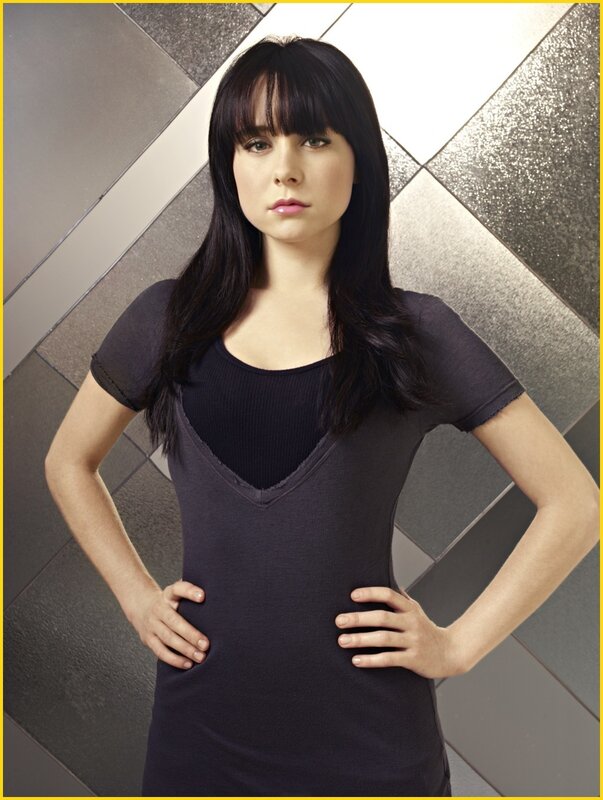 woman in black top with hands on hips