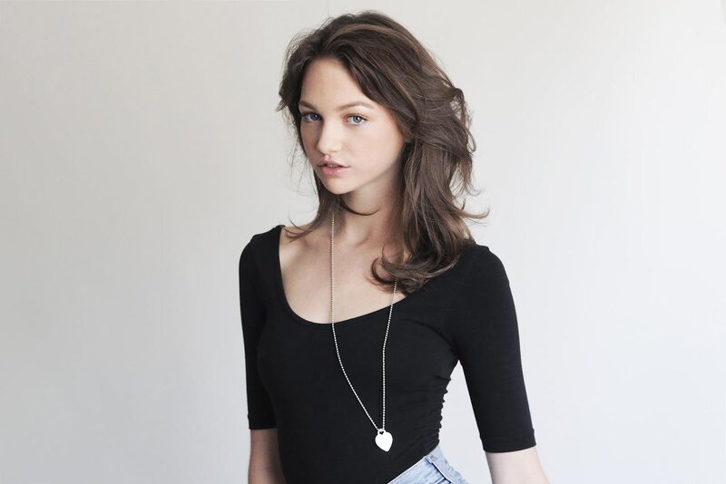 woman in black top with heart necklace