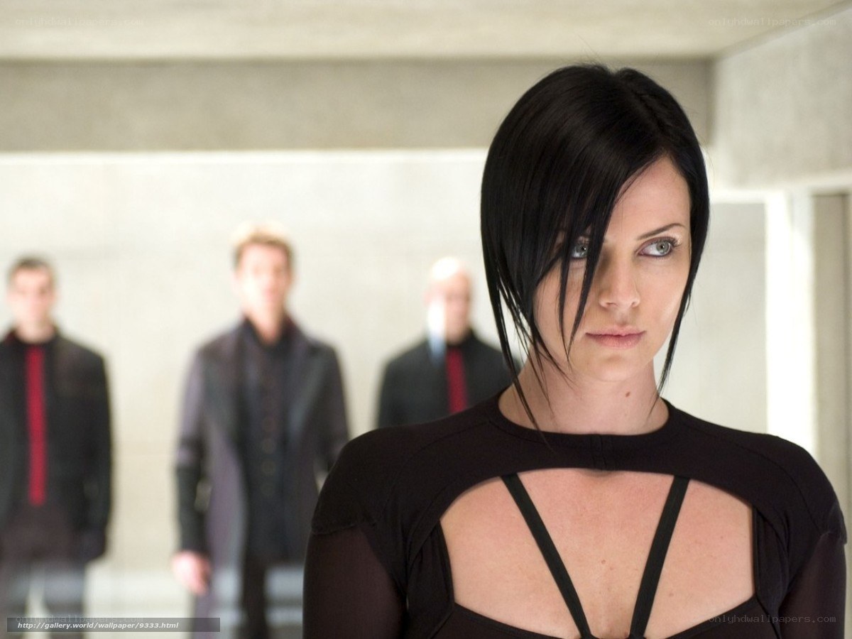 Woman in black top with men in background