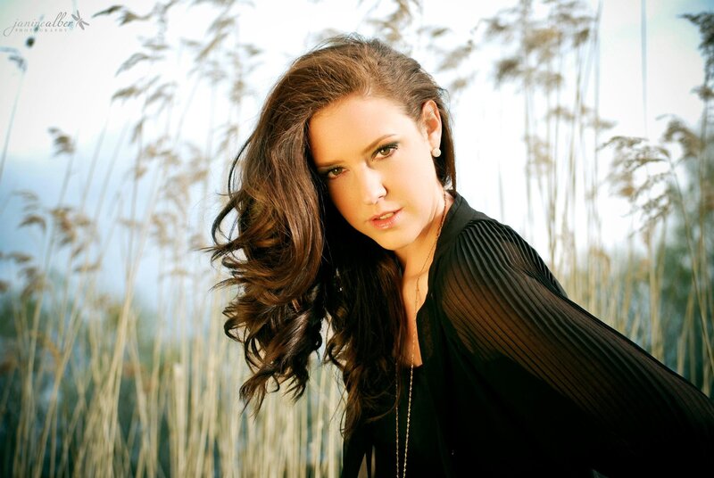woman in black top with reeds