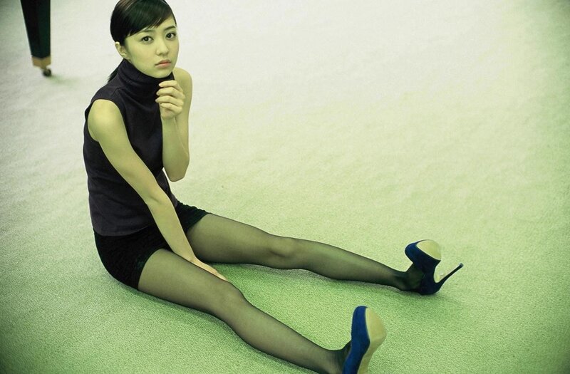 woman in black turtleneck sitting on floor