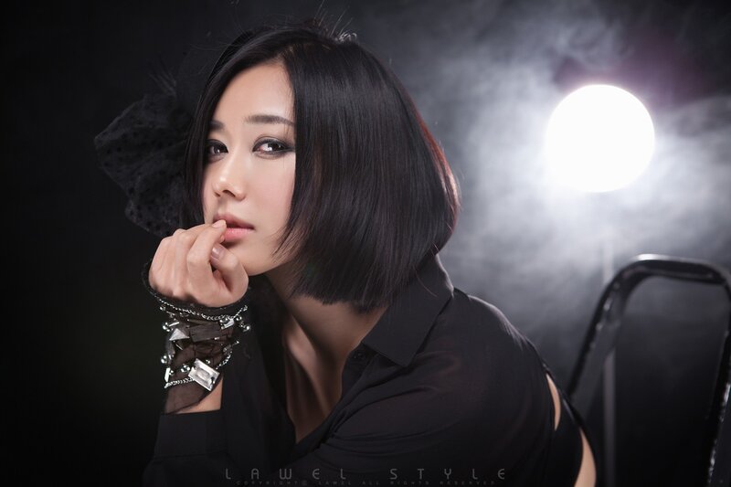woman in black with smoke background