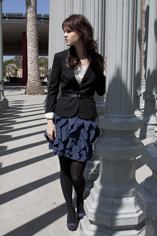 woman in blazer and ruffled skirt