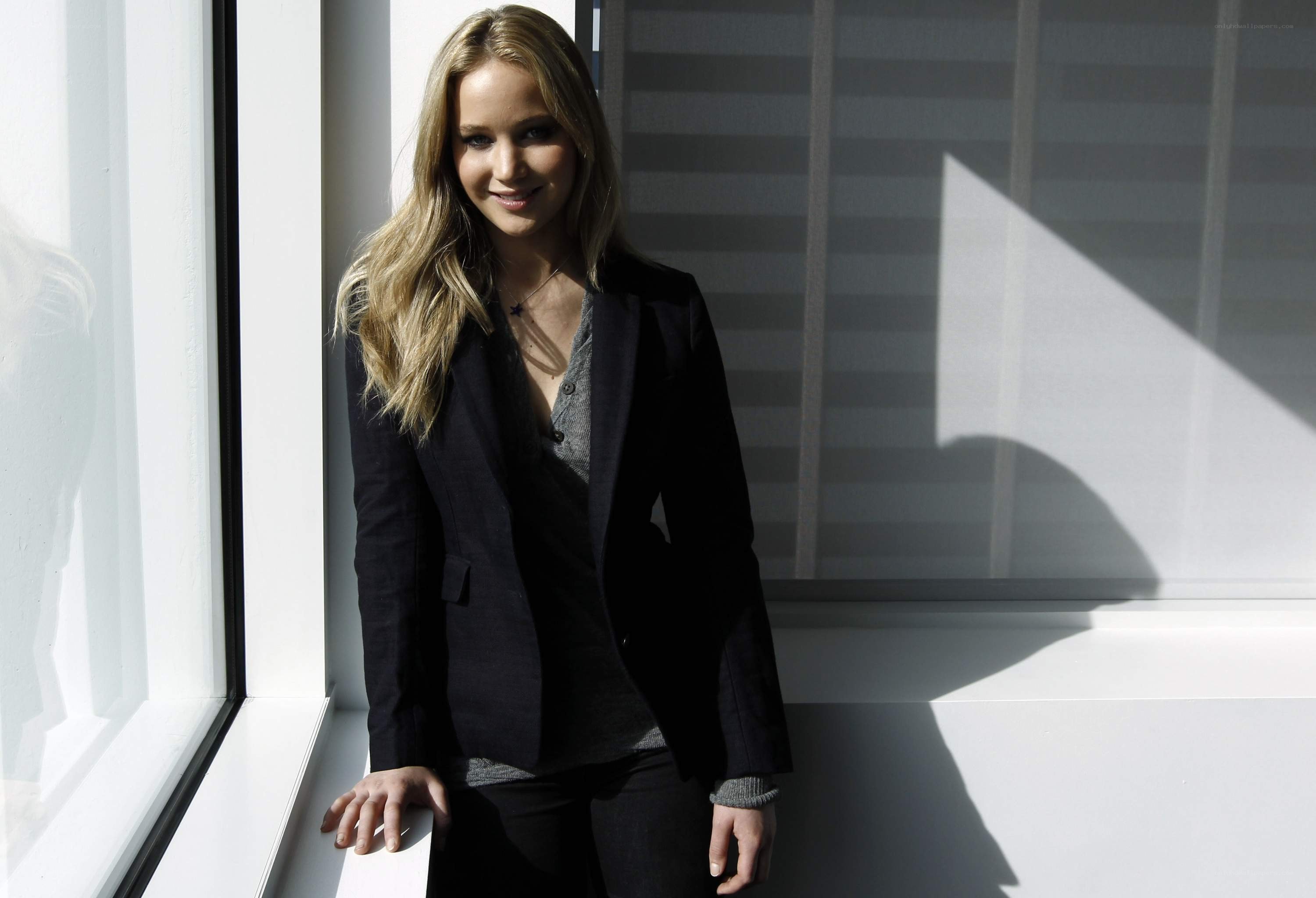 woman in blazer by window