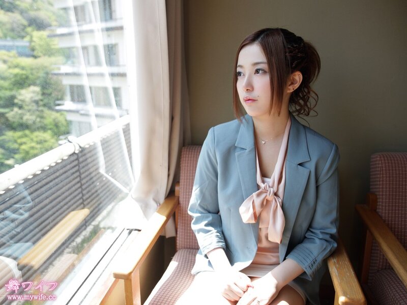 Woman in blazer by window