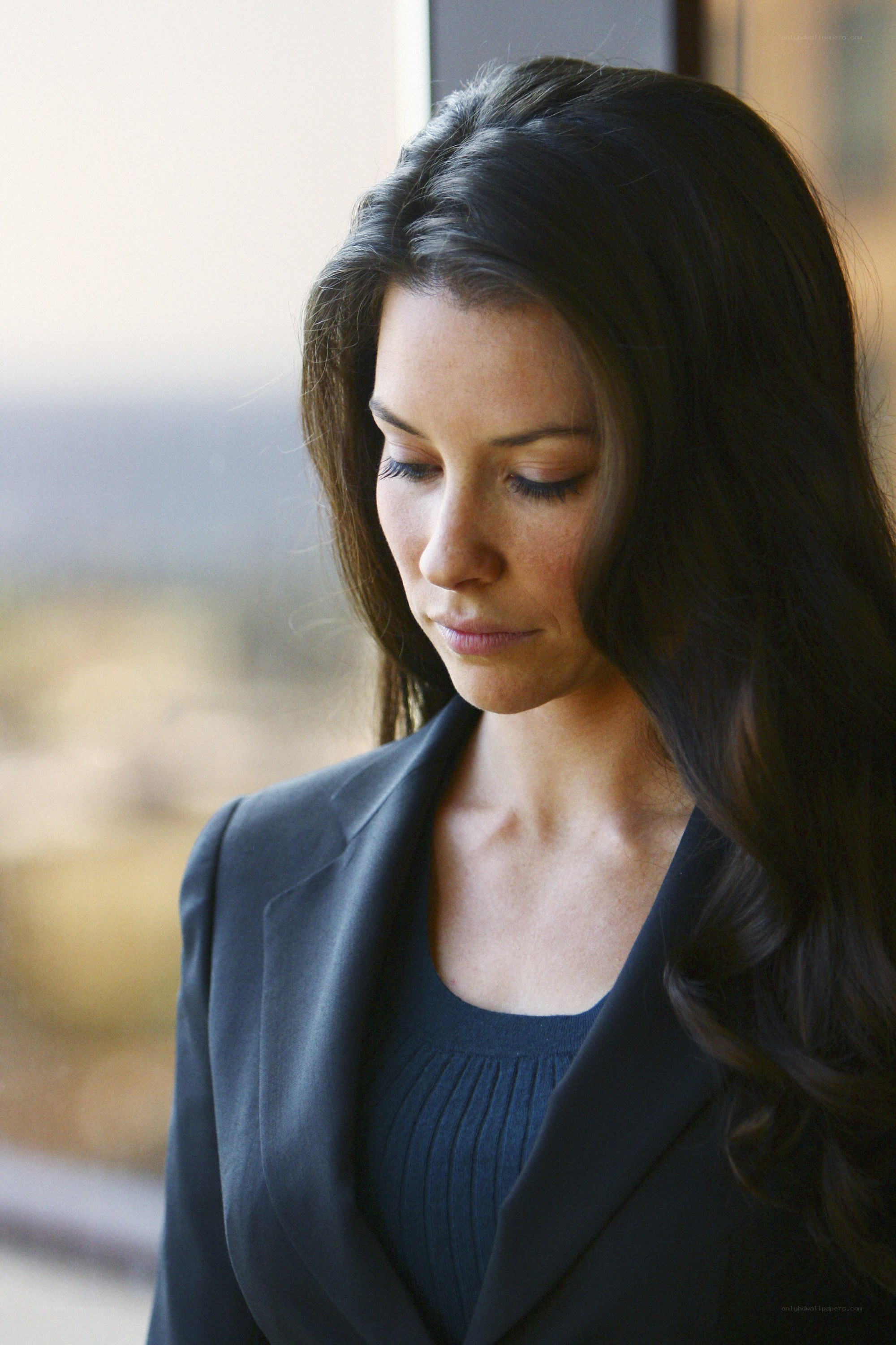 woman in blazer looking down