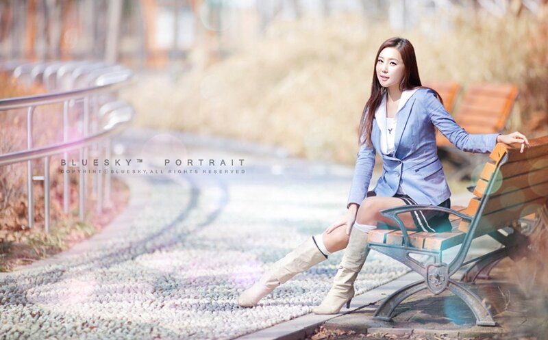 woman in blazer on bench