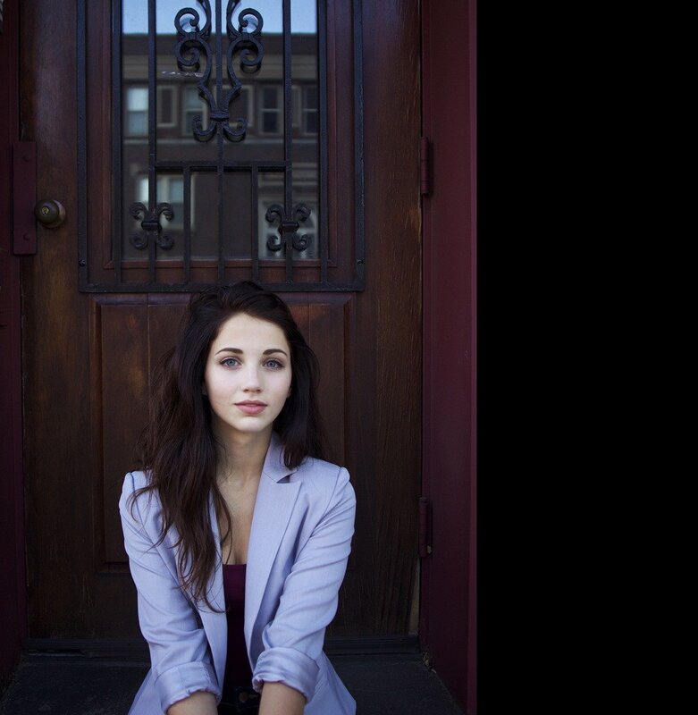 woman in blazer sitting on steps