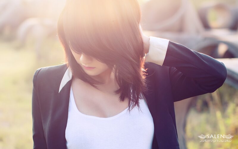 woman in blazer with sun flare