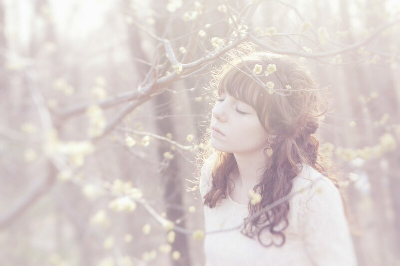 woman in blossoming trees