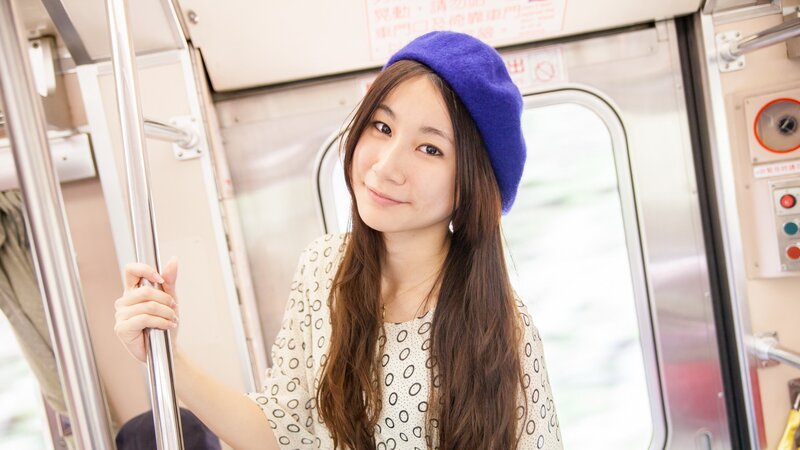 woman in blue beret on train