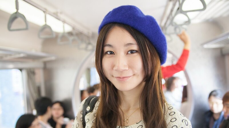 woman in blue beret on train